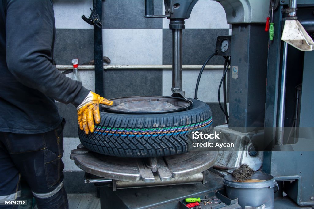 Serviceman Attaches New Wheel To Rim